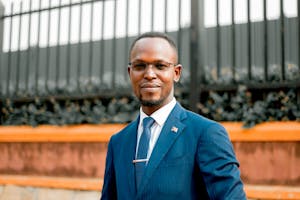 Portrait of a confident African American man in a blue suit outdoors.